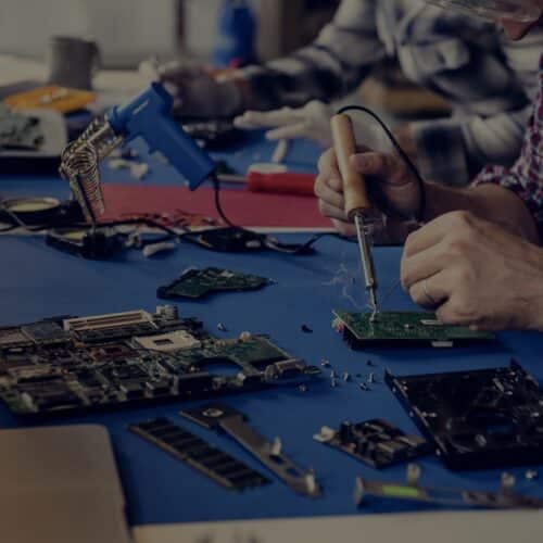 Hand soldering tin on electronics circuit board